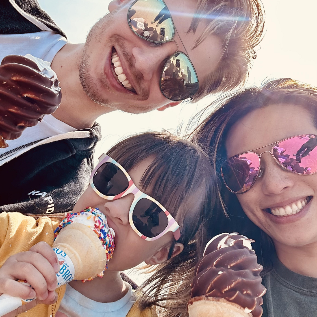 Janet, Jeff, and Rosie, wearing sunglasses and eating ice cream.